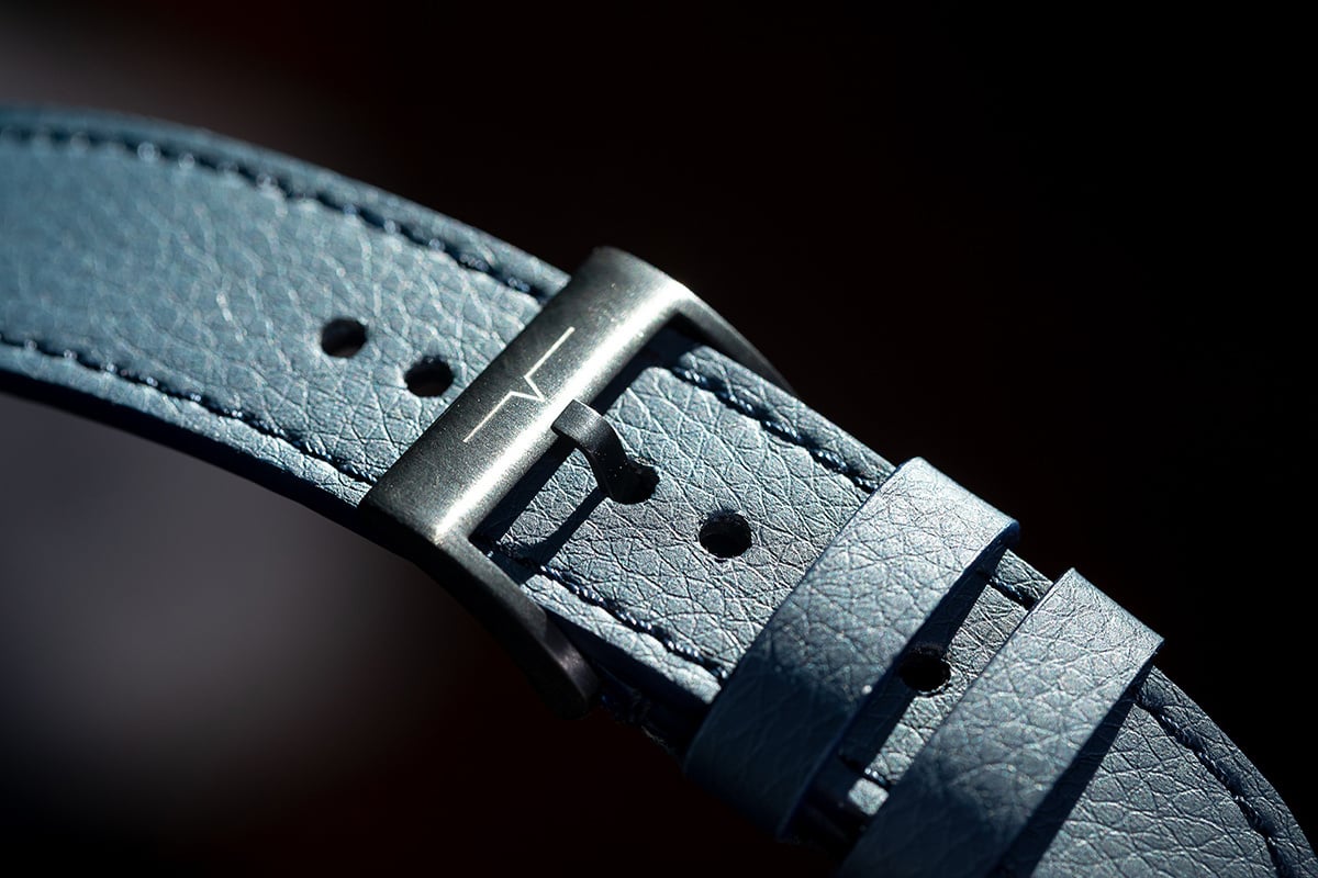 Macro product photograph showing the texture of a blue leather watch strap